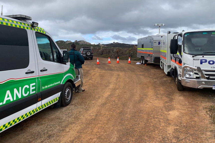Emergency service vehicles parked at a beach access road near Albany.