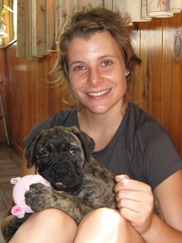 Heidi Reid smiles while holding a puppy, date and location unknown.