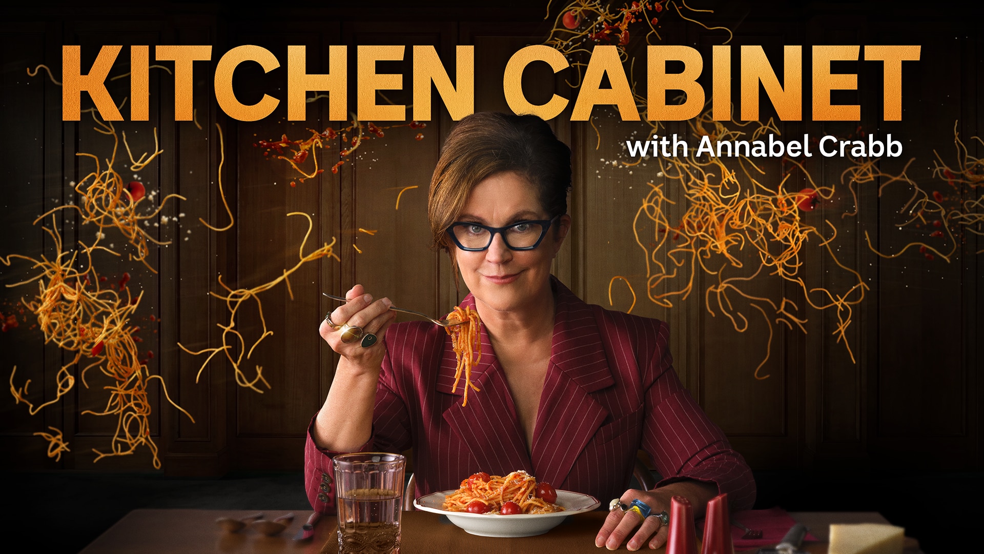 A woman sits at the table eating a bowl on spaghetti with a fork