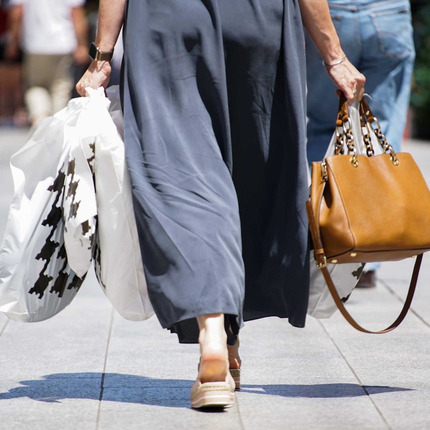 A woman carrying shopping bags.