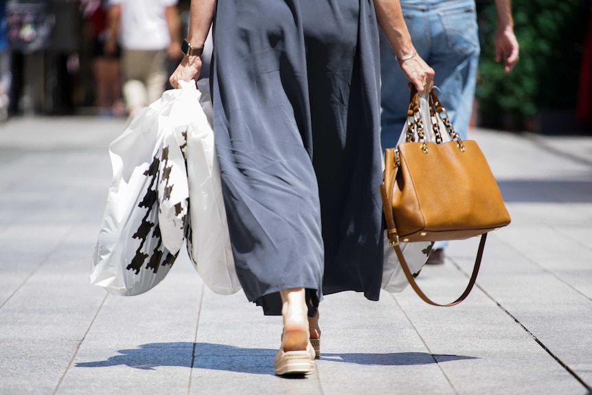 A woman carrying shopping bags.