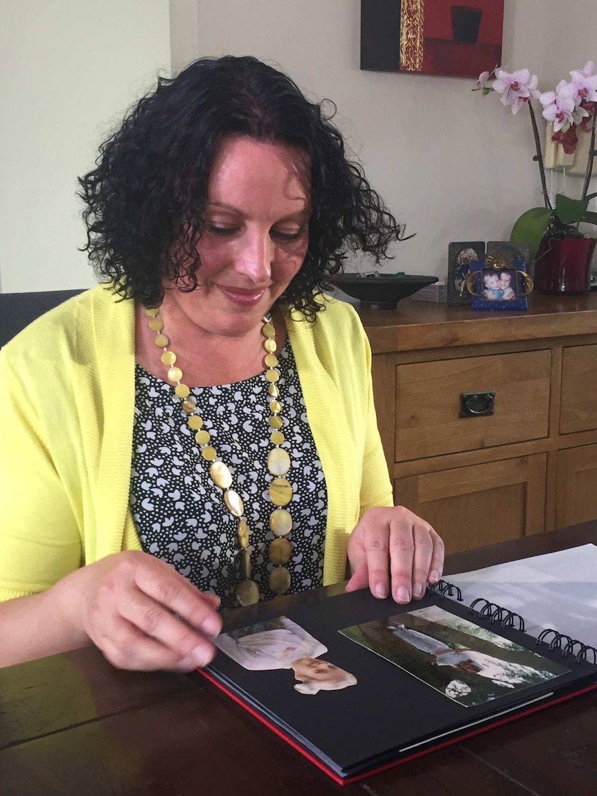 Dana Lee looking at photos of her younger sister Eve van Grafhorst.