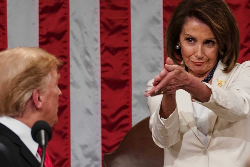 Man turning back to look at a woman wearing a white suit.