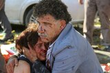 Injured man hugs an injured woman after an explosion during a peace march in Ankara, Turkey