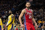 Ben Simmons is mean-mugging after a dunk. LeBron James looks frustrated behind him.