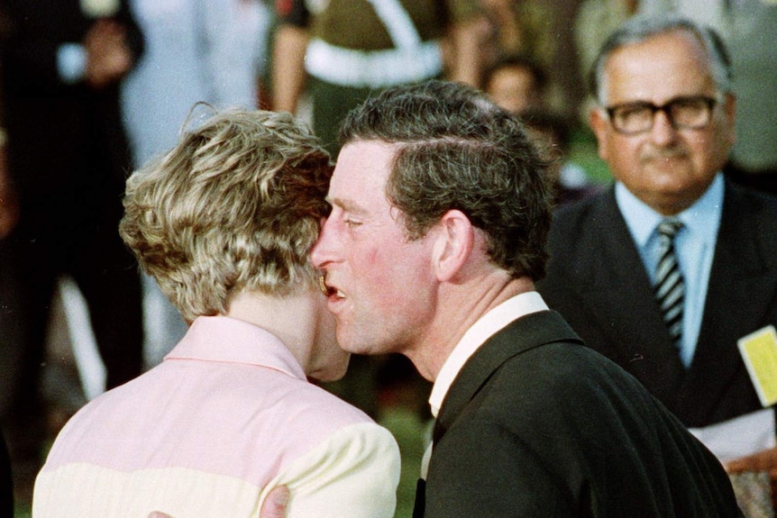 Prince Charles appears to awkwardly kiss or whisper to Princess Diana