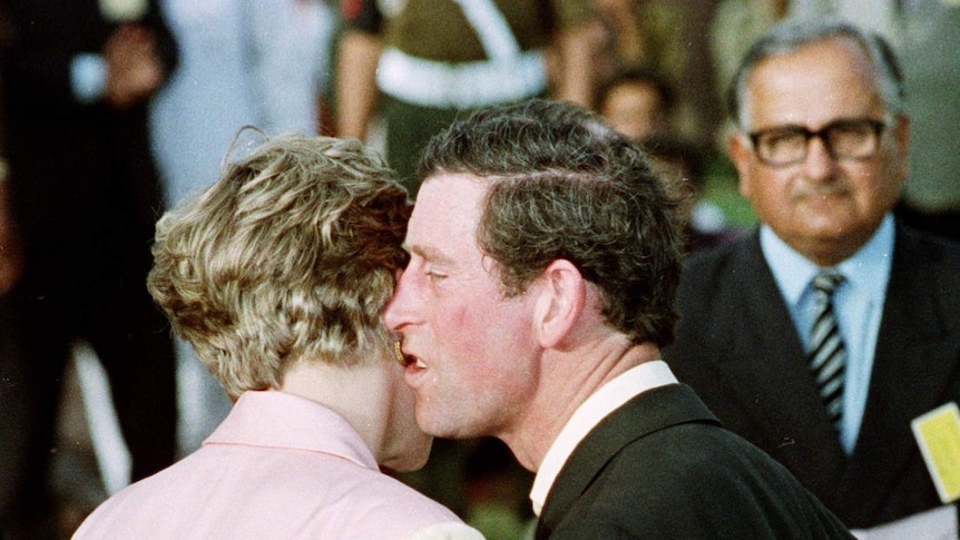 Prince Charles appears to awkwardly kiss or whisper to Princess Diana
