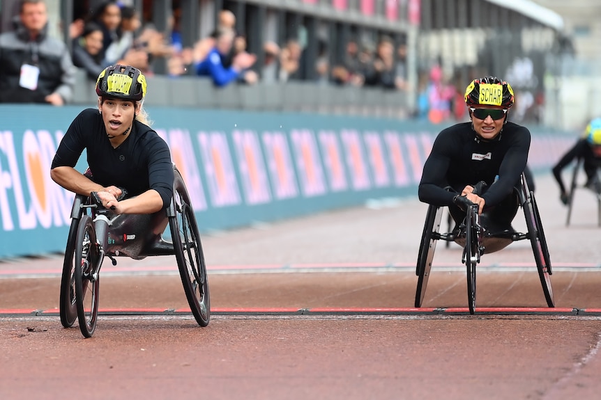An Australian female athlete crosses the line first in the women's wheelchair race at the London Marathon.