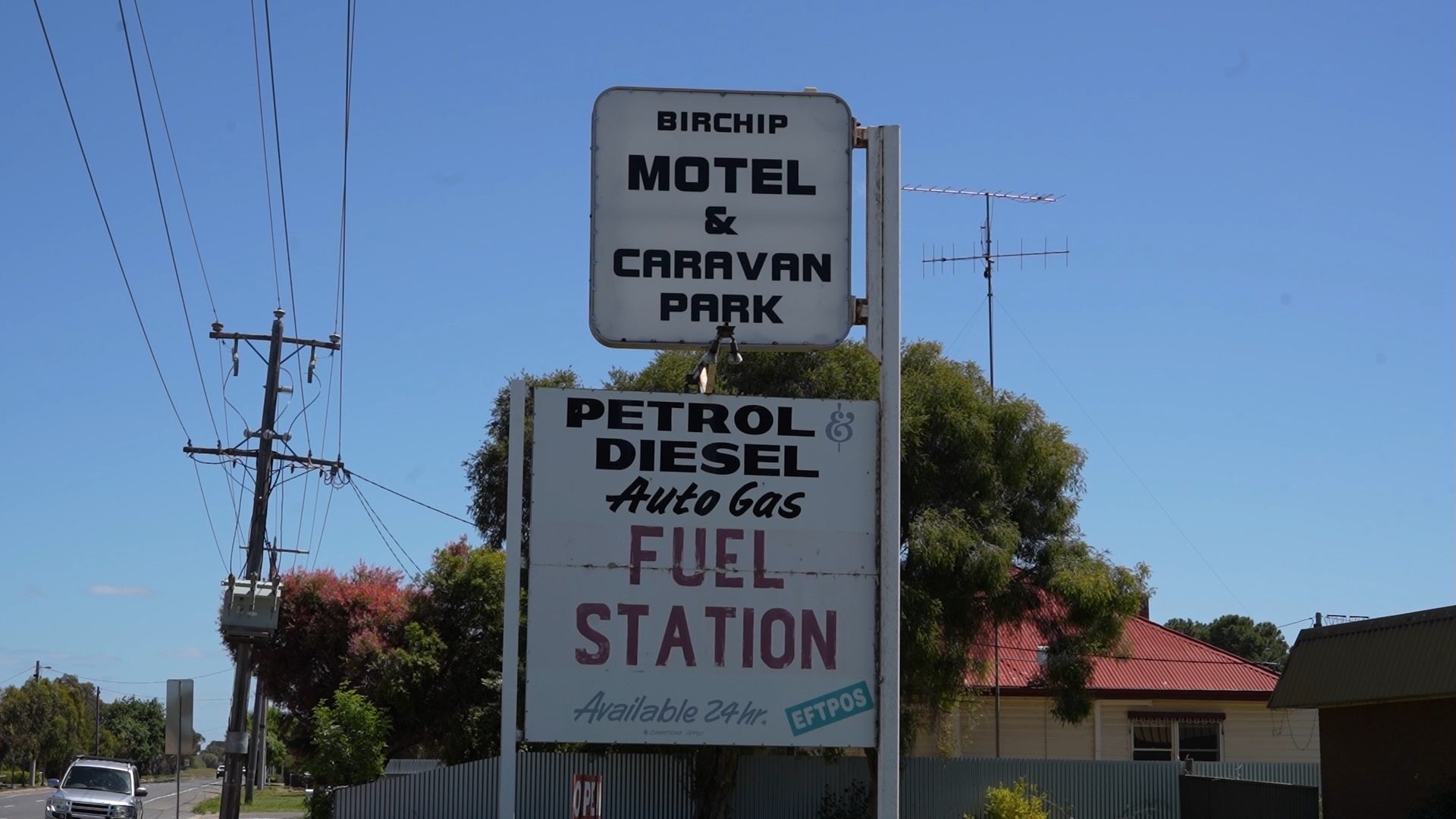 Sign for regional motel and caravan park, and sign saying "petrol and diesel fuel station"
