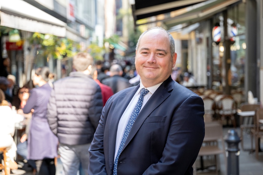 National Australia Bank chief executive Andrew Irvine stands in a laneway restaurant area.