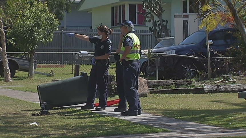 Police at crime scene where woman was allegedly attacked by former partner with machete