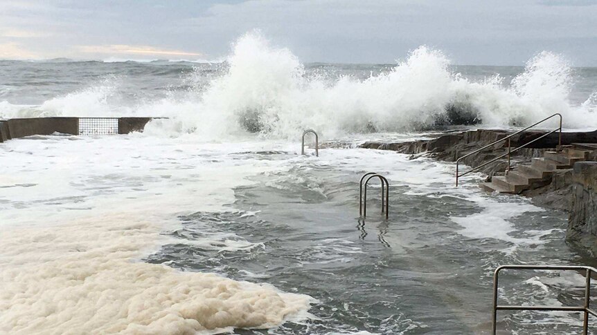 Waves crash over Yamba ocean pool