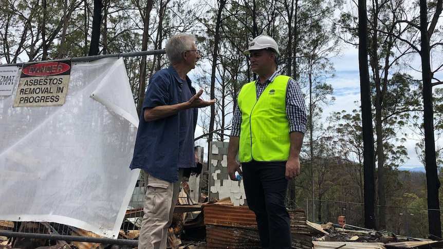 Deputy Premier John Barilaro meets with Peter Hassell in front of his burnt down home