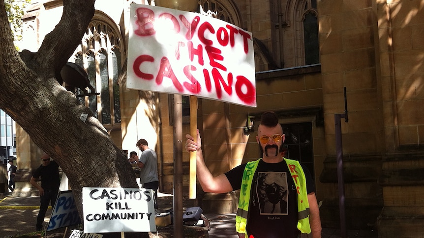 A man holds up a sign calling on people to boycott the city's casinos.