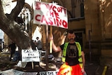 A man holds up a sign calling on people to boycott the city's casinos.