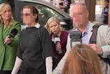 William Tyrrell's foster mother in a black jumper and white shirt underneath, walking with her husband outside court 
