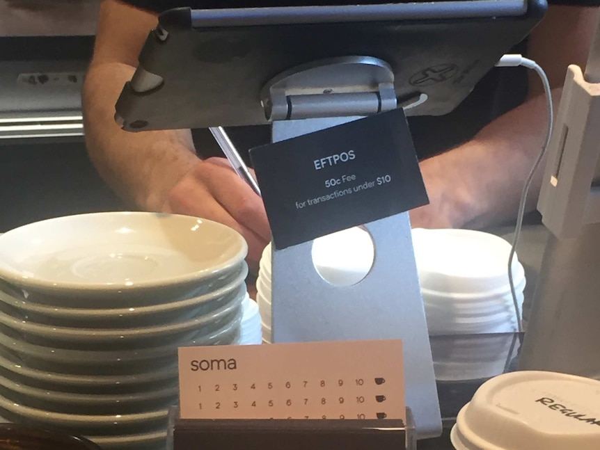 Notice in Sydney cafe advertising 50 cent EFTPOS surcharge for transactions under $10