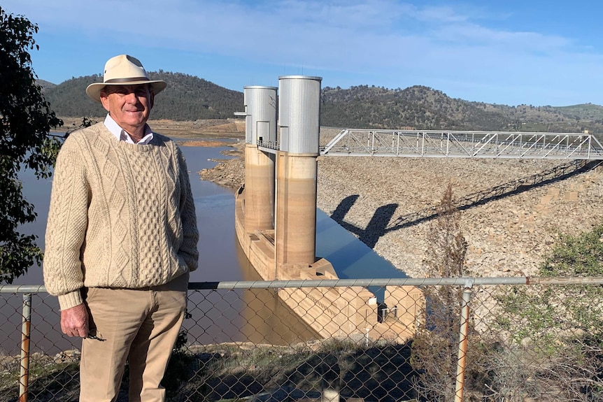 man standing in front of NSW dam