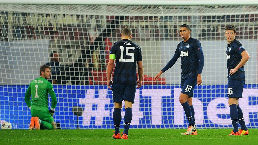 Manchester United's defenders react after conceding to Olympiacos in the Champions League.