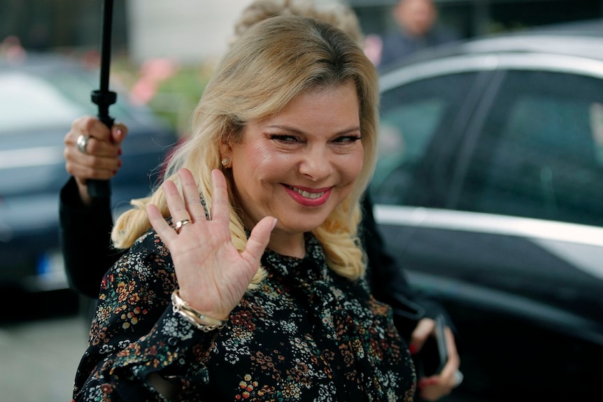 Sara Netanyahu, the wife of Israel's Prime Minister Benjamin Netanyahu, waves and smiles.