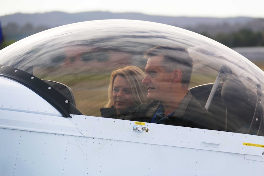 Steven and Christine Mogg sit in their plane.