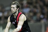 Mark McVeigh of Essendon carries the ball (action pic)