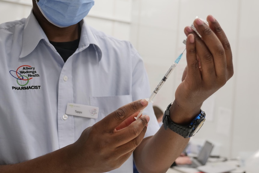 albury wodonga health pharmacist drawing covid vaccination in needle