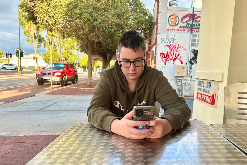 boy looking at mobile phone 