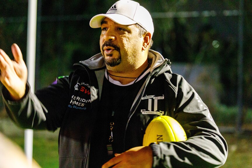 A man coaching an AFL training session