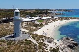 An aerial photo of the Bathurst Lighthouse in front of a series of premium tents at Rottnest Island.