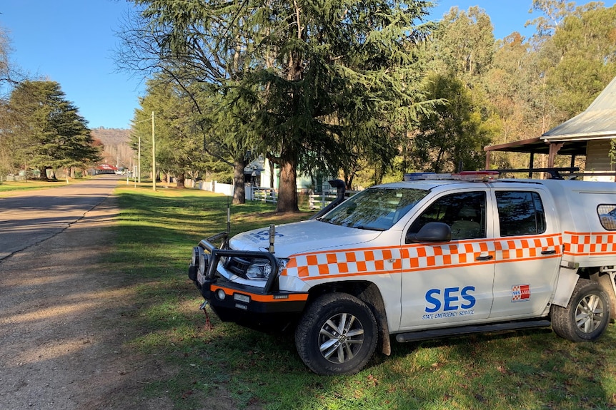 A State Emergency Service four-wheel-drive is parked beside a homestead on a country road.