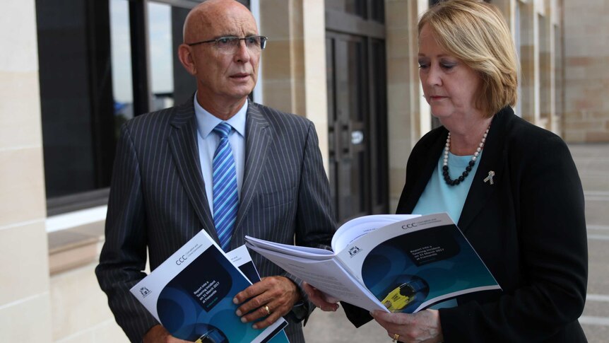 Attorney-General John Quigley and Police Minister Michelle Roberts stand outside WA Parliament holding a CCC report.