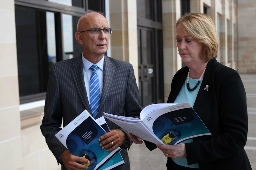Attorney-General John Quigley and Police Minister Michelle Roberts stand outside WA Parliament holding a CCC report.