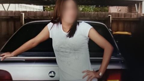 A girl, Alyssa, whose face is blurred, leans on a car in a relaxed way.