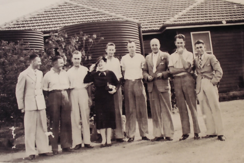 A group of ABC staff stand outside the original 4RK headquarters in Gracemere in the 1930s.