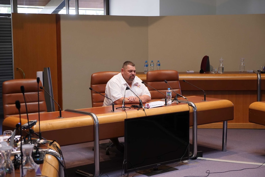Barkandji Native Title Group CEO, Derek Hardman, sitting inside the Broken Hill City Council chambers.