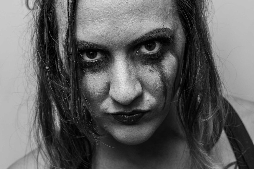 Close-up, black-and-white image of wrestler Madison Eagles.