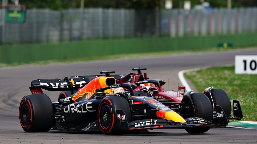 A Formula 1 driver pushes his car outside a rival going around a corner during a sprint race.