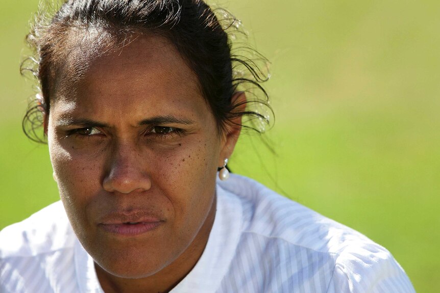 Close-up photo of Cathy Freeman looking slightly-off-centre at an event at the Australian Sports Commission in 2011.