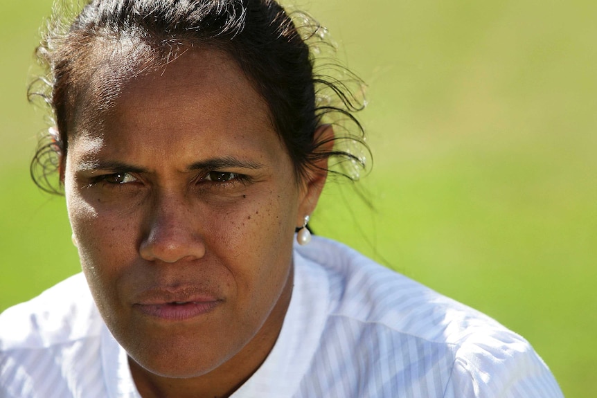 Close-up photo of Cathy Freeman looking slightly-off-centre at an event at the Australian Sports Commission in 2011.