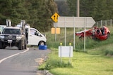 A crumpled red car and white van involved in a car crash. 