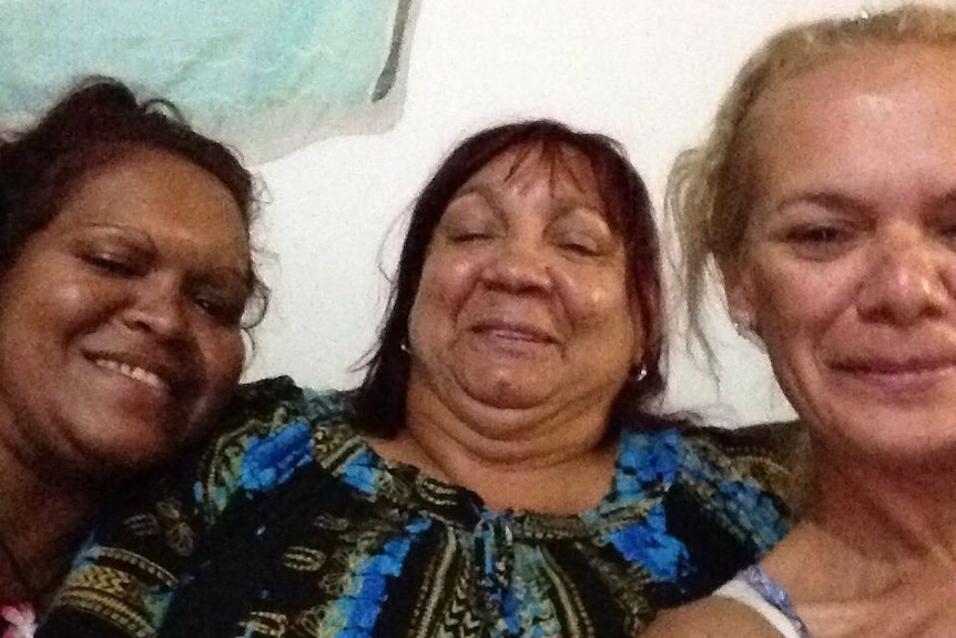 A selfie of three women with one pulling a thumbs up.