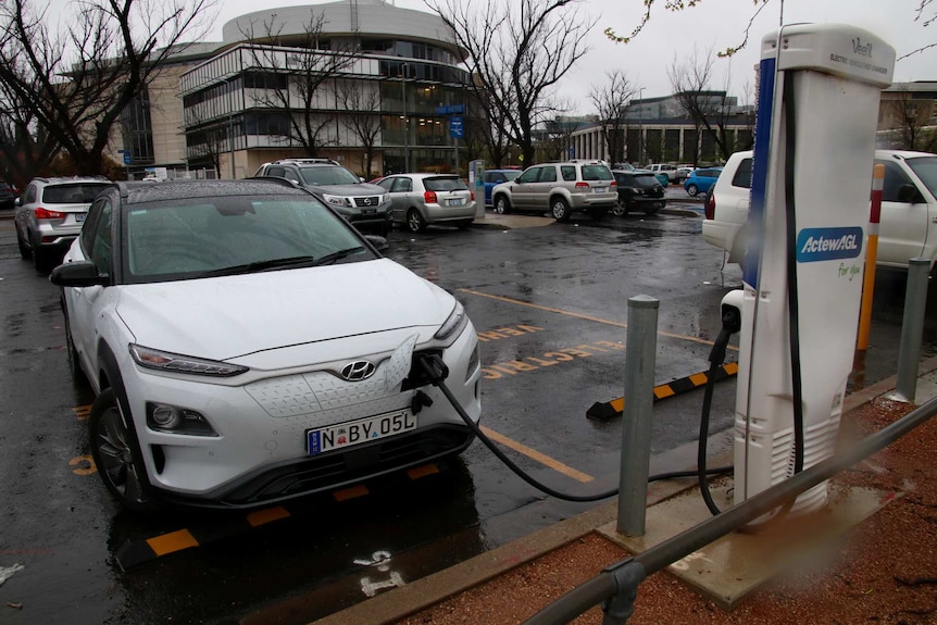 Electric car charging in a car park