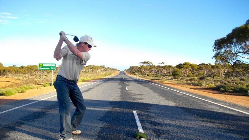 A golfer drives down the Eyre Highway