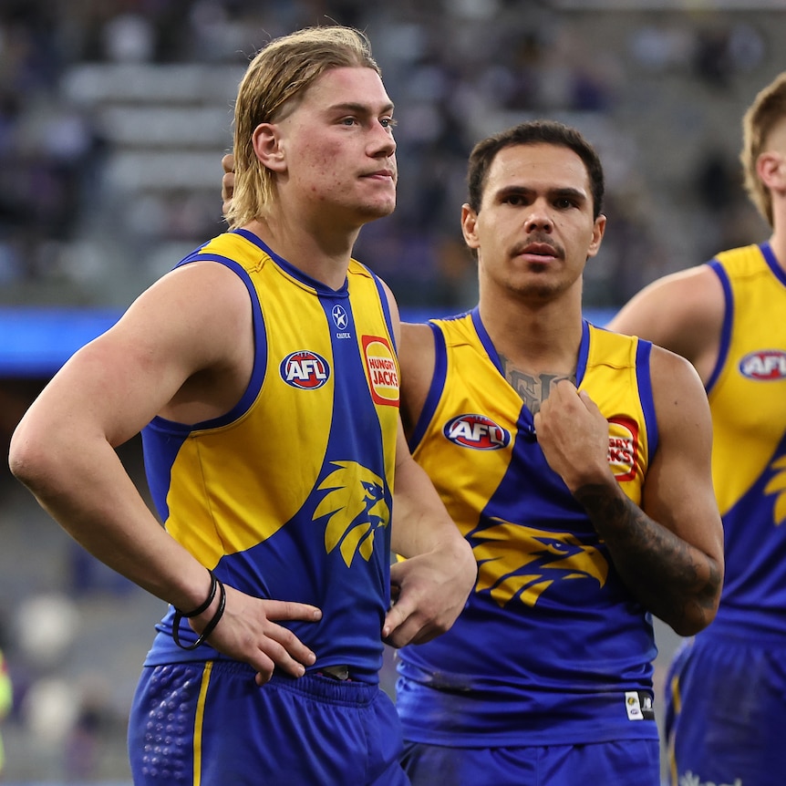 Harley Reid stands with Eagles teammates after AFL loss to Saints.