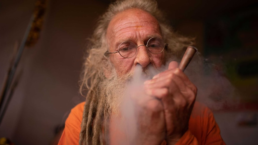 Australian sadhu Giri blowing hash smoke out of his nose.