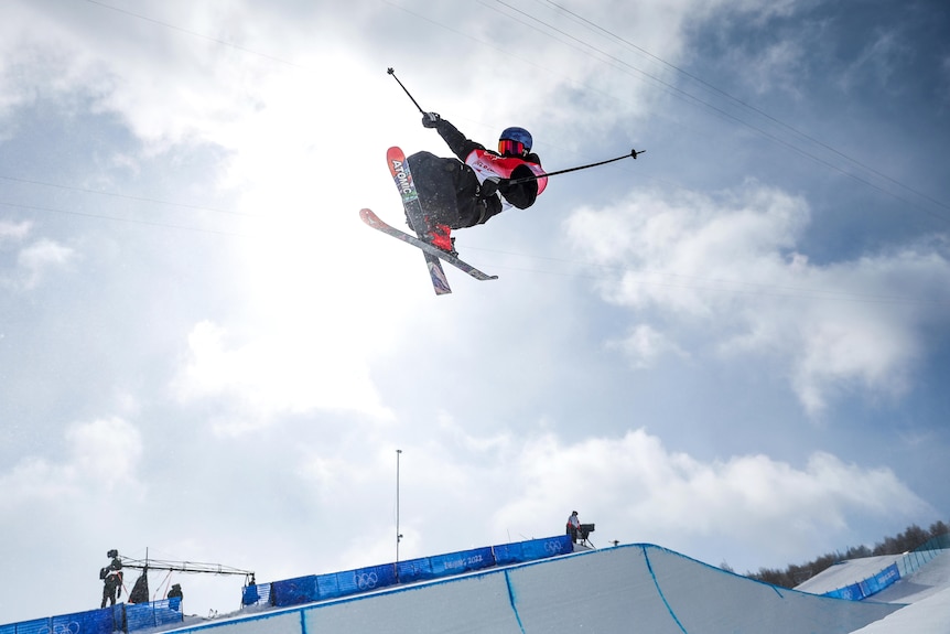 A skier flies through the air doing a trick.