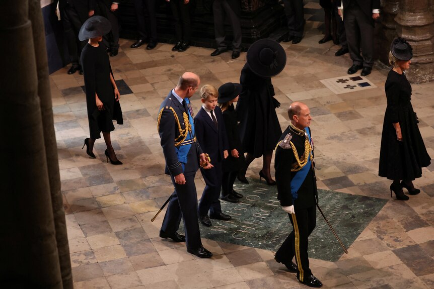 Prince Harry and Princess Kate walk into the abbey with Charlotte and George between them 