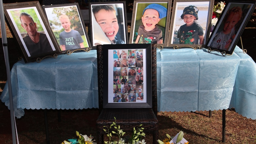 Photos of the five boys and their father, who were killed in a Russell Island, set up on a table at the memorial