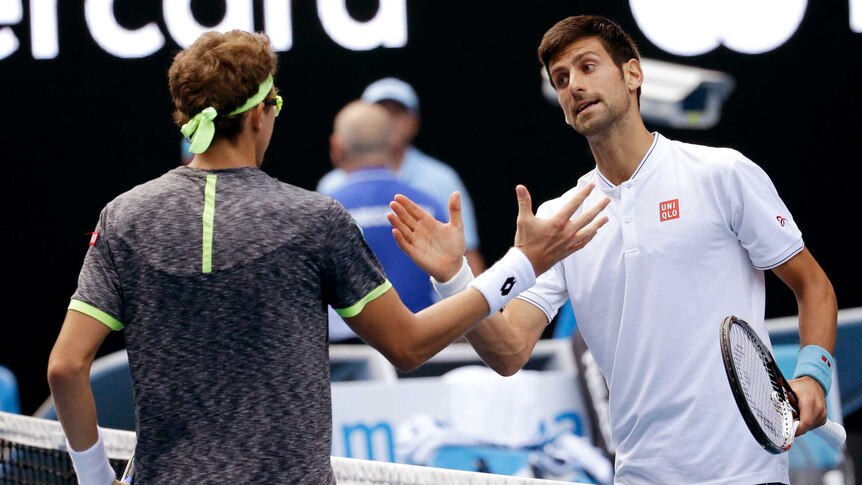 Novak Djokovic shakes hands with Denis Istomin
